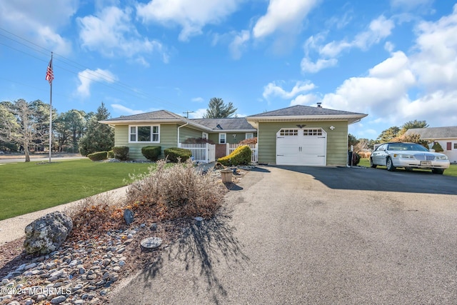 ranch-style house with a porch, a garage, and a front lawn