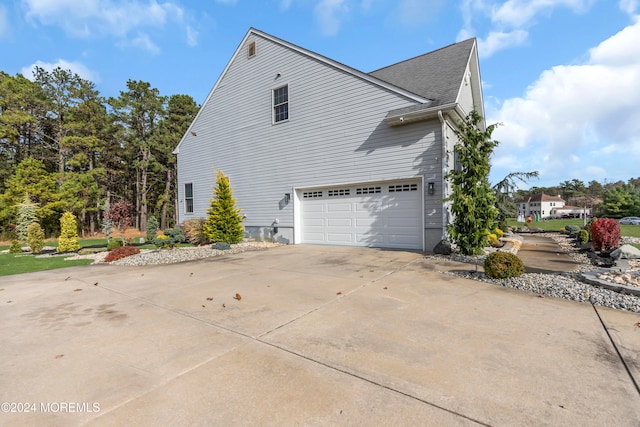 view of side of home with a garage