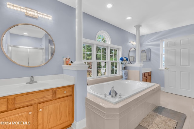 bathroom featuring vanity, tile patterned floors, a wealth of natural light, and independent shower and bath