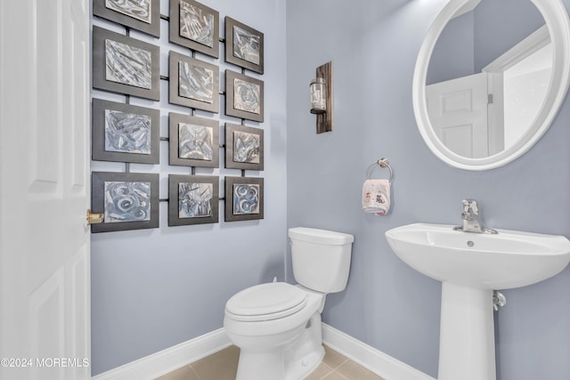 bathroom with tile patterned flooring and toilet