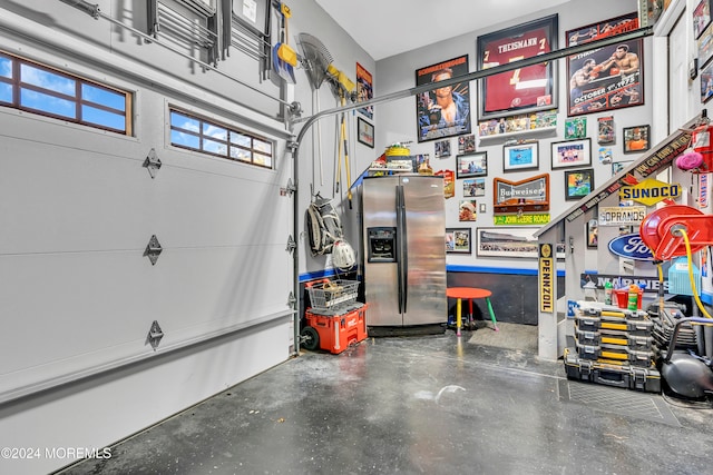 garage with stainless steel fridge with ice dispenser