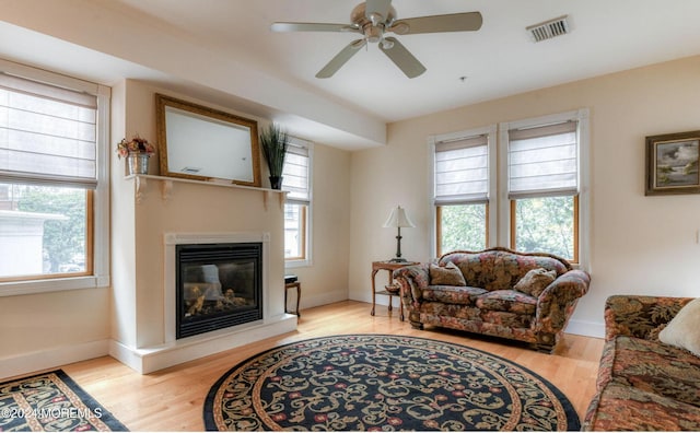 living room with ceiling fan and light hardwood / wood-style floors