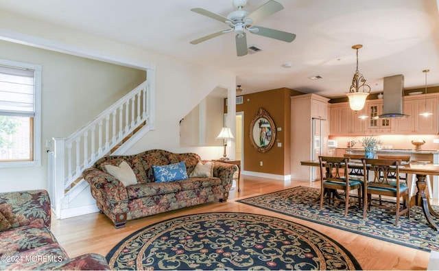 living room with ceiling fan and light wood-type flooring