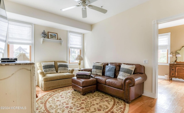 living room featuring light wood-type flooring and ceiling fan