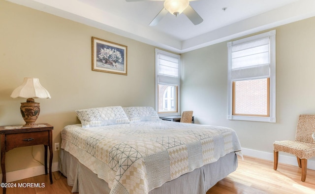 bedroom with light hardwood / wood-style floors and ceiling fan