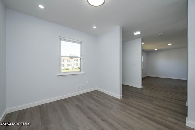 empty room with dark wood-type flooring