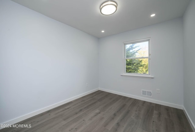 spare room featuring dark wood-type flooring