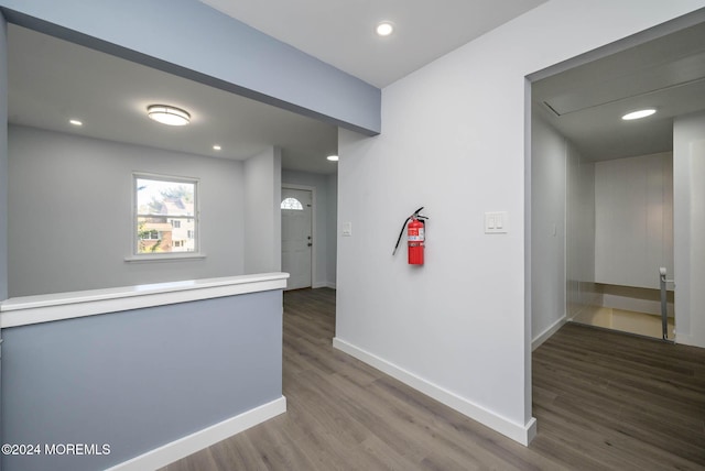 hallway with dark hardwood / wood-style floors