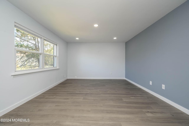 empty room with hardwood / wood-style flooring