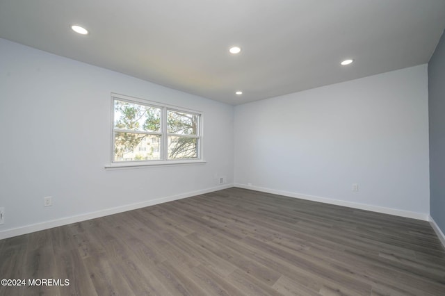 empty room featuring dark wood-type flooring