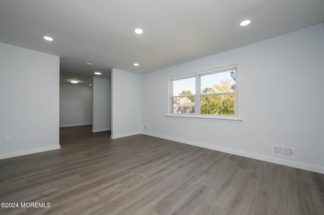 unfurnished room with dark hardwood / wood-style floors