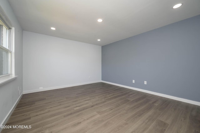 spare room featuring dark wood-type flooring