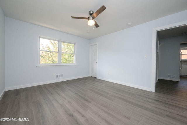 unfurnished room with dark hardwood / wood-style flooring and ceiling fan