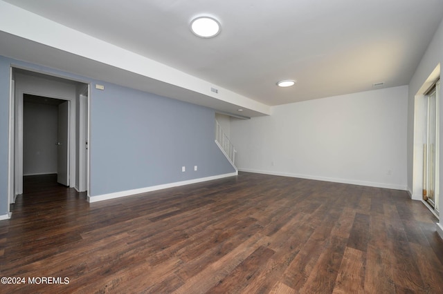 basement with dark hardwood / wood-style flooring