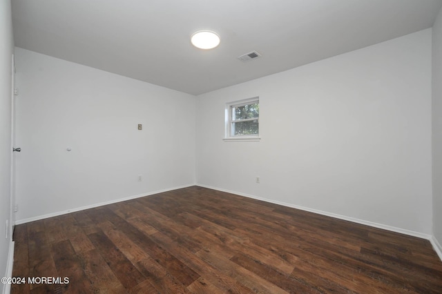 unfurnished room featuring dark hardwood / wood-style floors