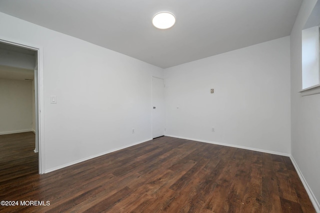 spare room with dark hardwood / wood-style floors