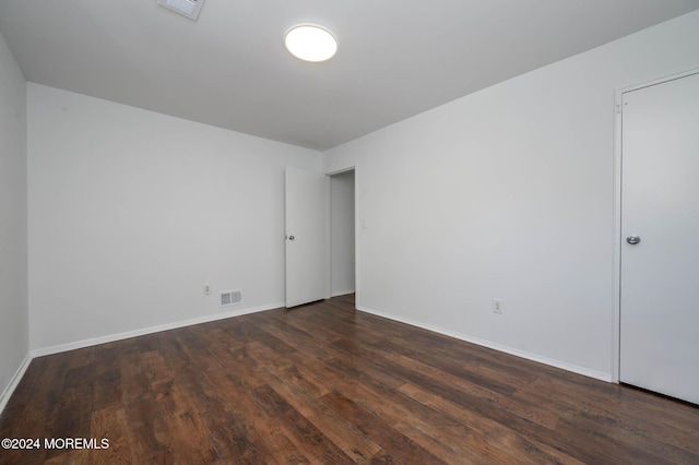 unfurnished room with dark hardwood / wood-style floors