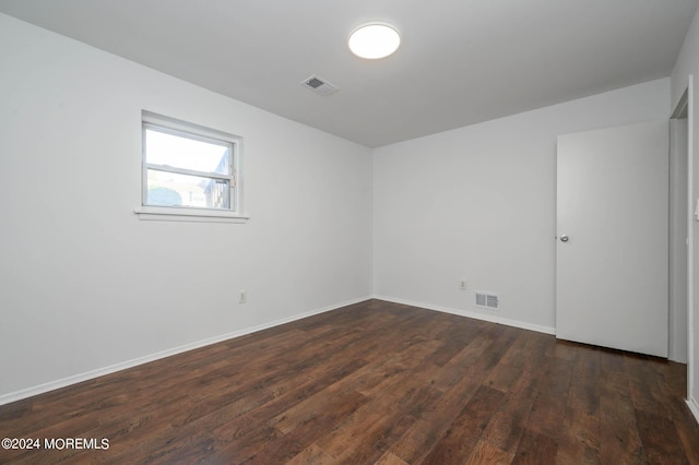 empty room with dark hardwood / wood-style floors