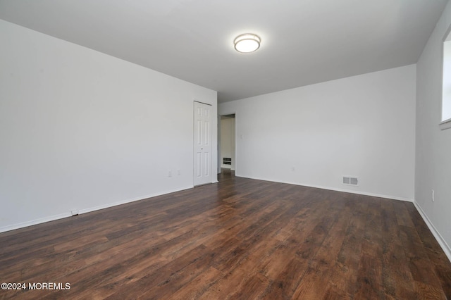 spare room with dark hardwood / wood-style flooring