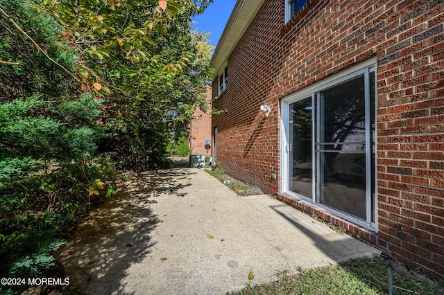 view of property exterior with a patio area