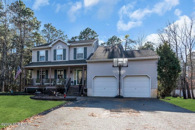 view of front facade with a front yard, a porch, and a garage