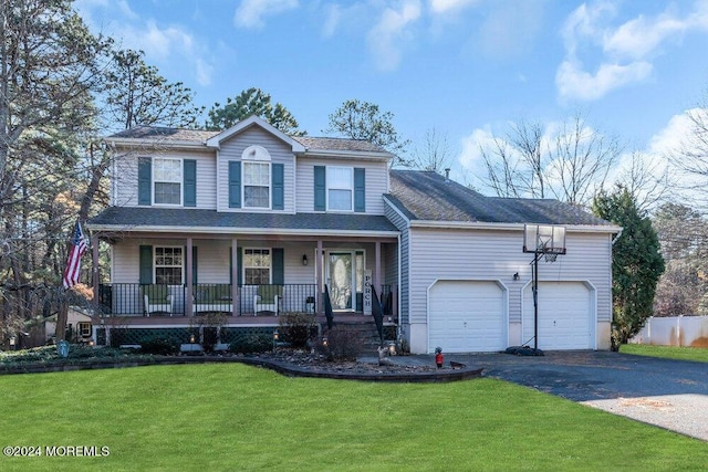 view of front of home with a front lawn, a porch, and a garage