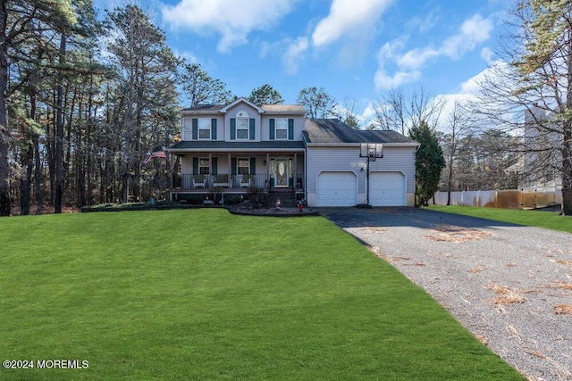 view of front of property with a garage, a porch, and a front yard