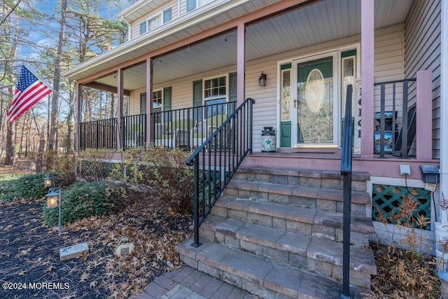 view of exterior entry with covered porch