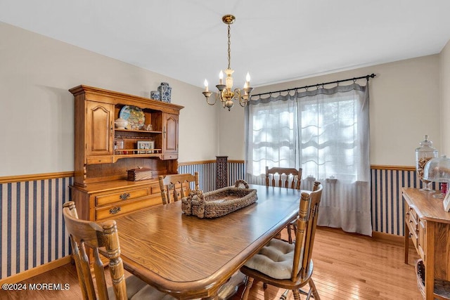 dining room with a notable chandelier and light wood-type flooring