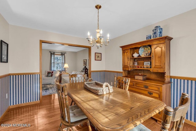 dining room with a chandelier and hardwood / wood-style flooring