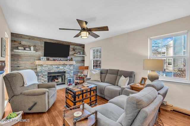 living room with ceiling fan, wood-type flooring, and a fireplace