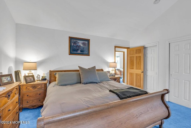 carpeted bedroom with lofted ceiling