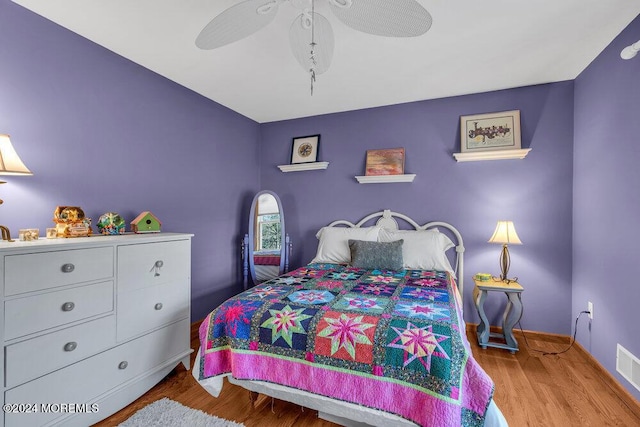 bedroom with light hardwood / wood-style floors and ceiling fan