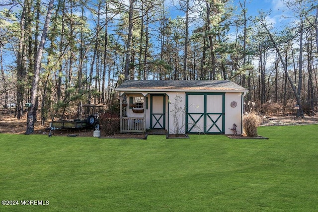 view of outdoor structure featuring a lawn