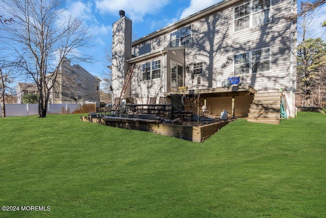 rear view of house with a yard