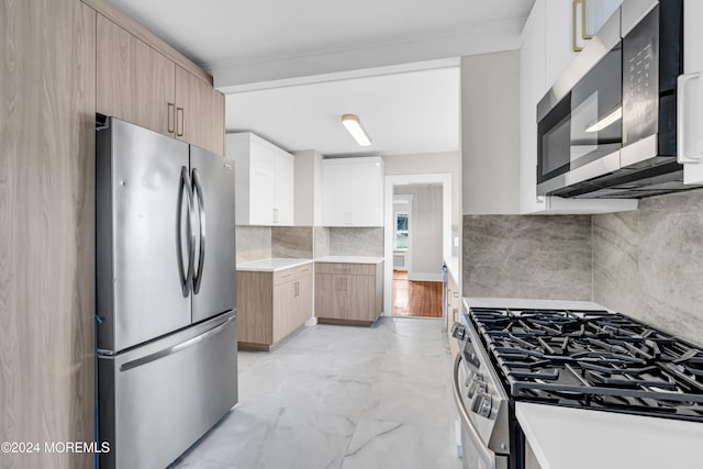 kitchen featuring white cabinets, decorative backsplash, light brown cabinets, and appliances with stainless steel finishes