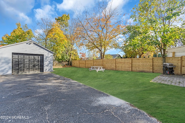 view of yard with an outbuilding and a garage