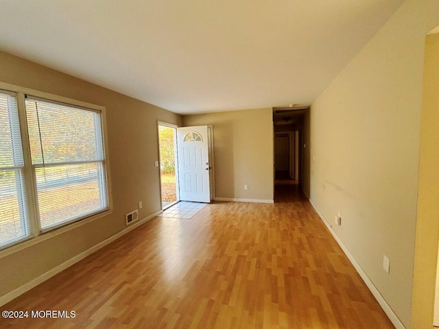 spare room with light hardwood / wood-style flooring