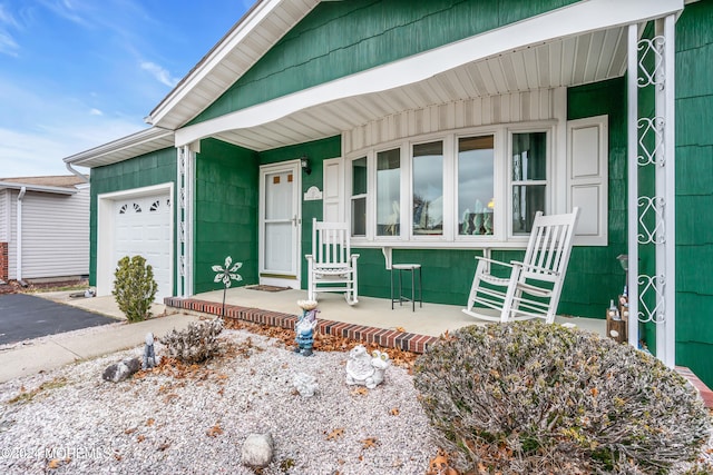 view of front of home featuring covered porch and a garage