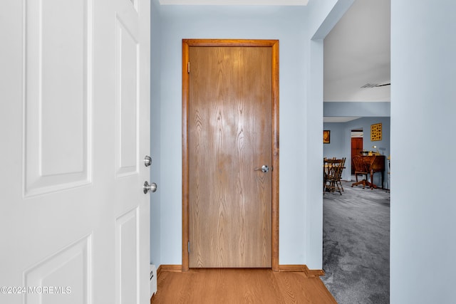 corridor with light hardwood / wood-style flooring