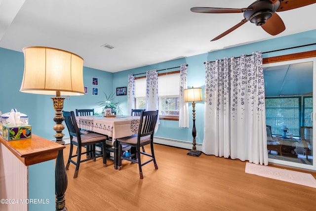 dining area with a baseboard radiator, light hardwood / wood-style flooring, and ceiling fan