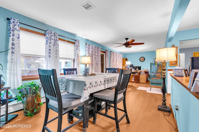 dining area featuring beamed ceiling, ceiling fan, and light hardwood / wood-style flooring