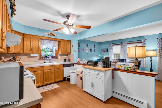 kitchen featuring kitchen peninsula, ceiling fan, a baseboard heating unit, light hardwood / wood-style floors, and range hood