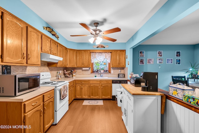 kitchen featuring backsplash, white appliances, ceiling fan, sink, and light hardwood / wood-style floors