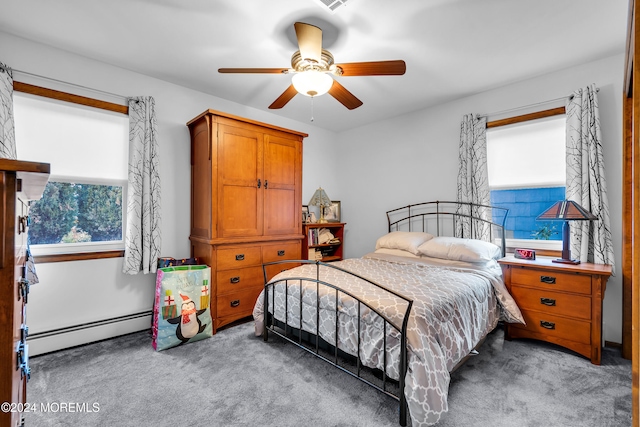 carpeted bedroom with ceiling fan and baseboard heating