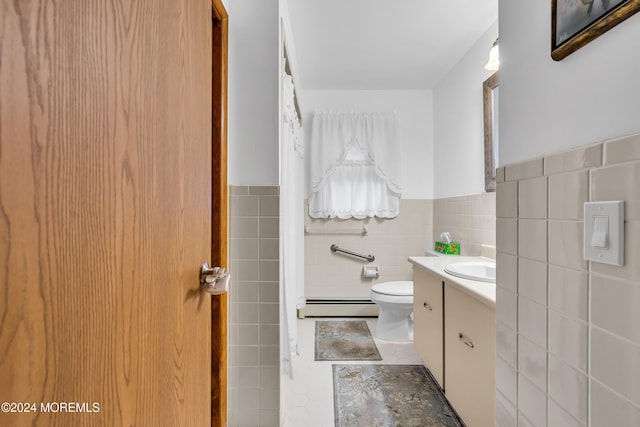 bathroom with toilet, vanity, baseboard heating, and tile walls