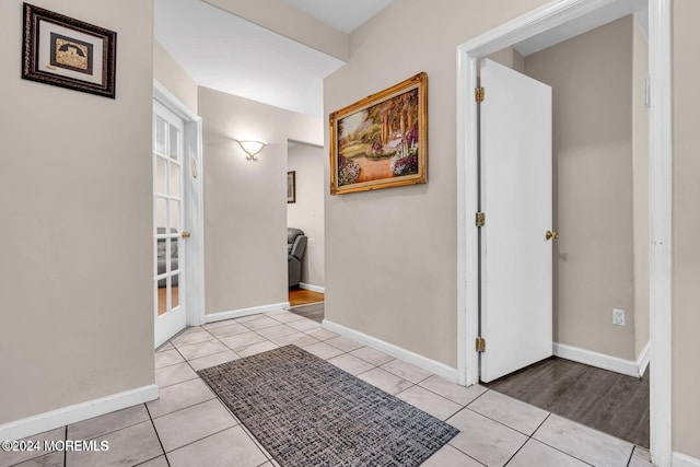 corridor featuring light tile patterned floors