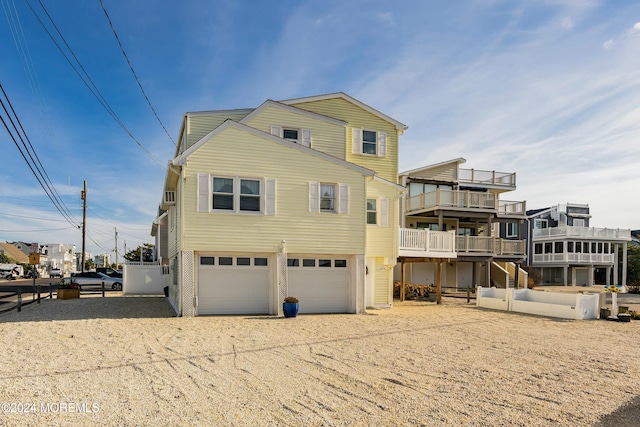 rear view of property with a garage