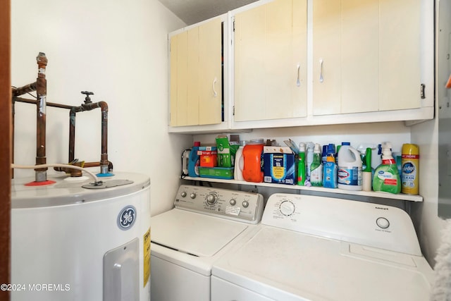 laundry room with cabinets, washing machine and dryer, and electric water heater