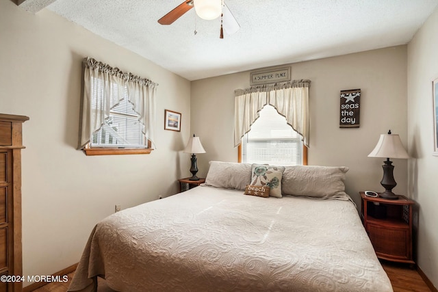 bedroom featuring a textured ceiling, hardwood / wood-style flooring, and ceiling fan